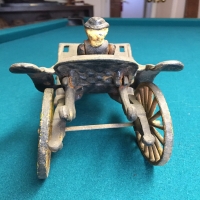 vintage-woman-in-carriage-metal-toy-14266493413.jpg