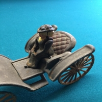 vintage-woman-in-carriage-metal-toy-1426649341.jpg
